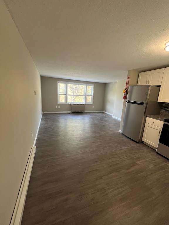A kitchen with a refrigerator, dishwasher, and oven.