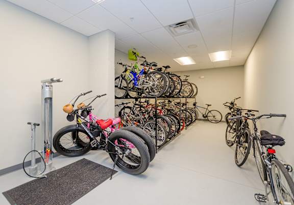 A room full of bicycles parked on the wall.