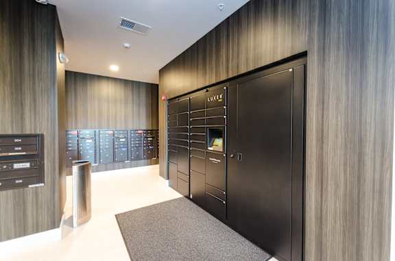 A black door with a glass panel and a sign that says "LUXE" on it.