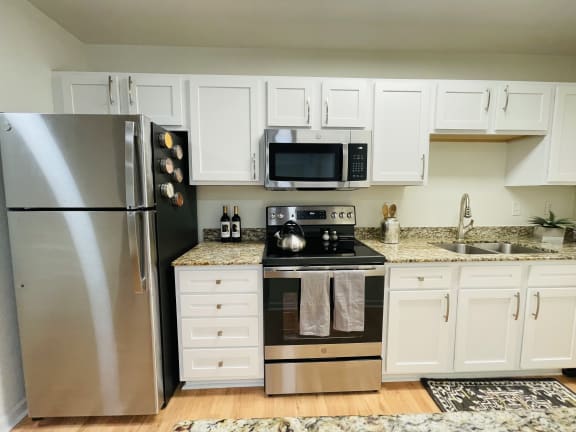 a kitchen with stainless steel appliances and white cabinets
