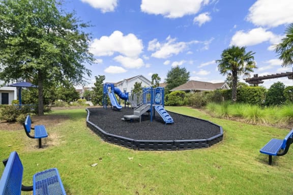 a playground with blue chairs and a black trampoline at Century HomePlace, Prattville, 36066