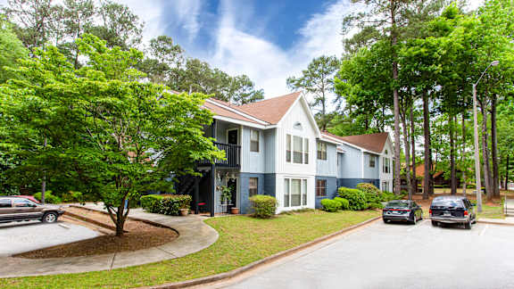 Two story residential building with parking area at Salem Glen Apartments, Conyers, GA 30013