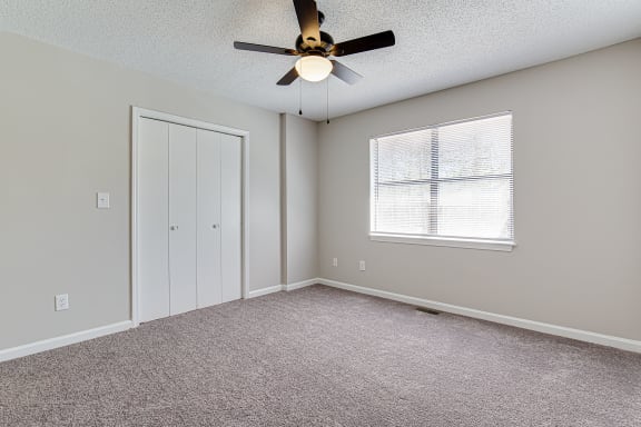 Vacant bedroom with closet and natural light at Salem Glen Apartments, Conyers, GA