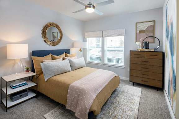 a bedroom with a bed and a ceiling fan at Century Mundy Mill Apartments, Georgia