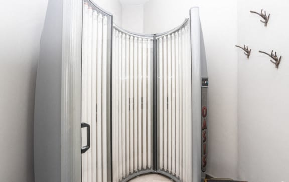 a bathroom with a shower stall with a metal gate