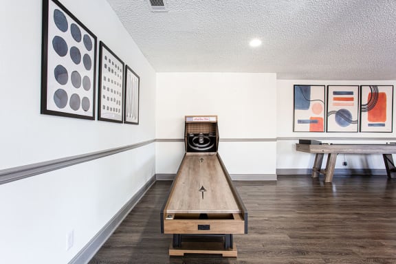A room with a bowling alley and artwork on the wall at The Carter 4250 Apartments, Georgia