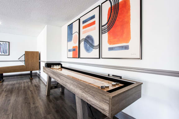 A pool table with a billiard set on it at The Carter 4250 Apartments, Norcross