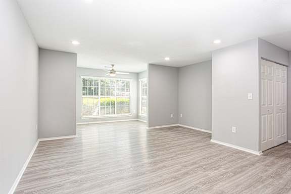 an empty living room with grey walls and a window at Keita 1875, College Park, GA 30349