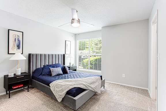 a bedroom with a bed and a large window at Keita 1875, College Park, GA