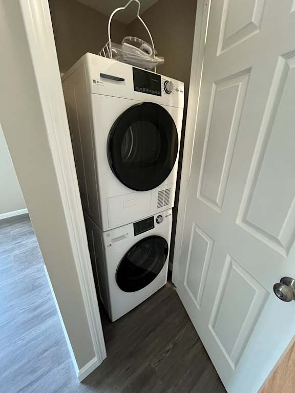 A white washer and dryer are stacked on top of each other in a small space.