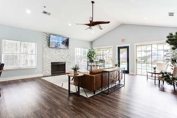 A living room with a fireplace and a TV mounted on the wall at Wildcreek Apartments, Clarkston, 30021