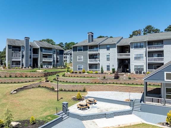 A large apartment complex with a courtyard and picnic tables.
