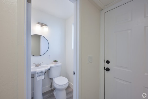 a bathroom with a toilet sink and a mirror