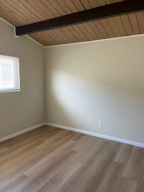 an empty room with a wooden floor and a window