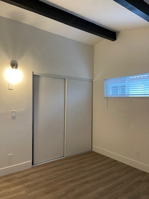 an empty room with a closet and a window