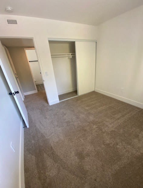 an empty bedroom with a closet