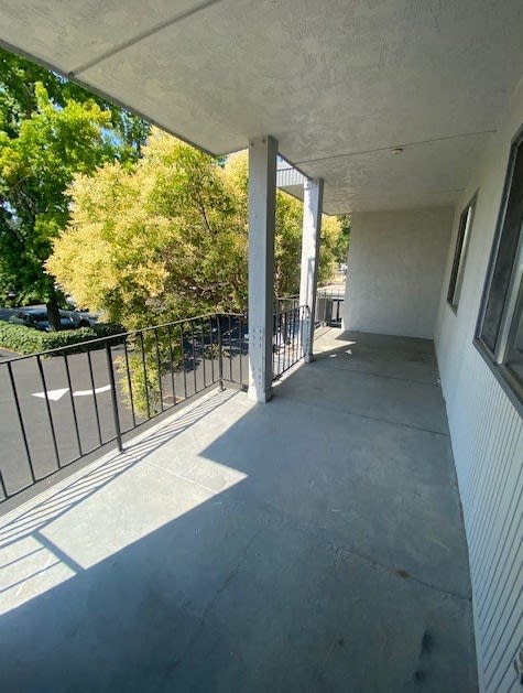 a balcony with a view of a park