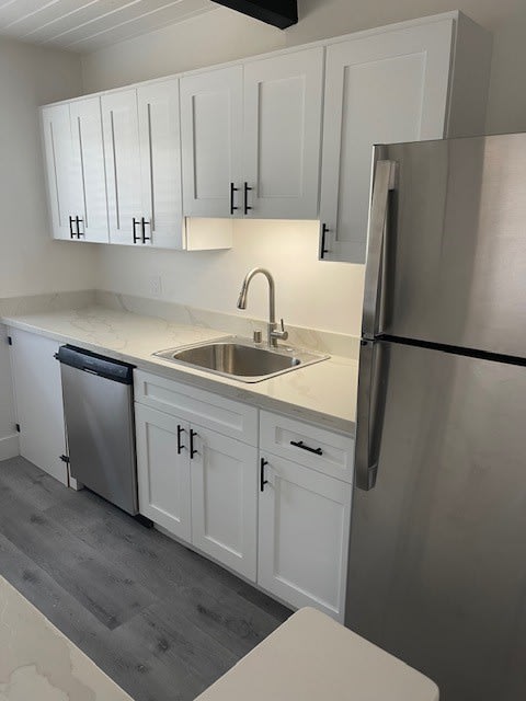 a kitchen with a sink and a refrigerator
