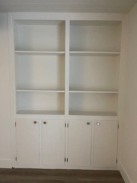 a white cabinet with white shelves and