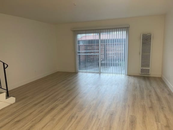 an empty living room with a large window