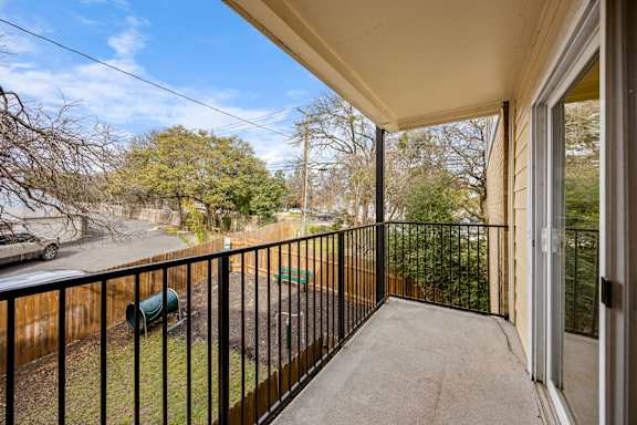 A balcony with a black railing at The Arbors at Tallwood, Austin