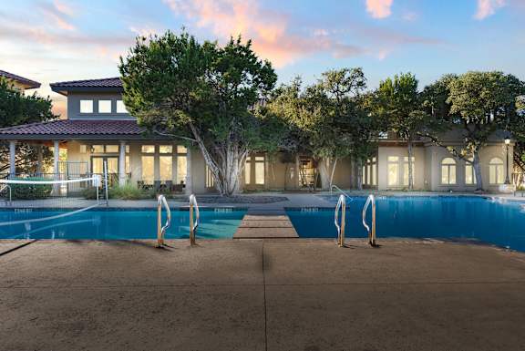 A large house with a pool in front of it. at Bridge at Heritage Woods, Texas, 78753