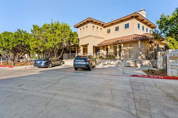 A house with a car parked in front of it. at Bridge at Heritage Woods, Austin, TX, 78753