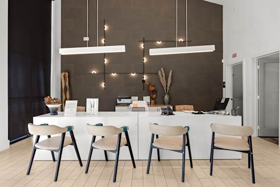 A modern kitchen with a white table and chairs. at Bridge at Tech Crossing, Austin, 78753