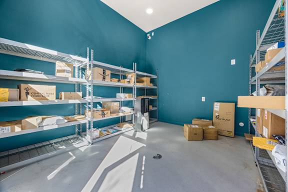 A warehouse with shelves and boxes. at Bridge at Tech Crossing, Texas