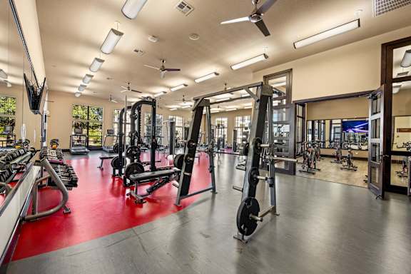 A gym with a variety of equipment including weights and machines. at The Royce at 8100, Austin, TX, 78729