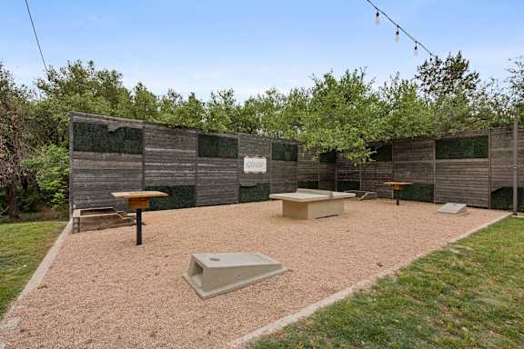 A backyard with a sandbox and a wooden fence. at Bridge at Canyon Creek, Texas