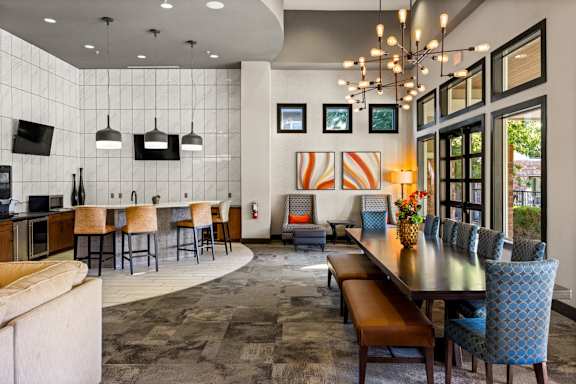 A modern dining room with a long table and chairs. at Bridge at Southpark Meadows, Austin, 78748