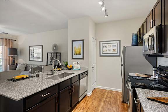 A kitchen with a refrigerator, microwave, and oven. at Bridge at Southpark Meadows, Austin, 78748