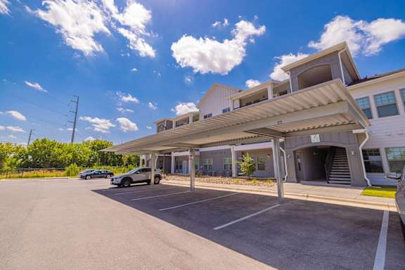 A parking lot with a building in the background.