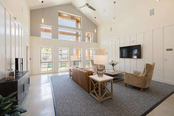 A living room with a grey carpet and a wooden coffee table.