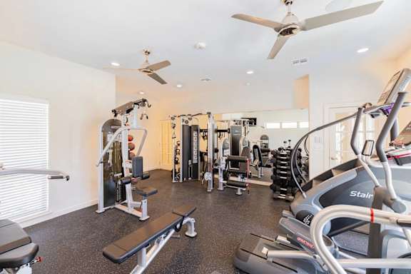 A spacious home gym with a variety of exercise equipment.