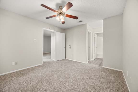 A room with a ceiling fan and carpeted floor. at Montecito, Austin, 78741