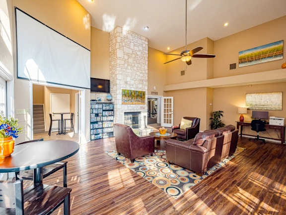 A living room with a fireplace and a painting on the wall.