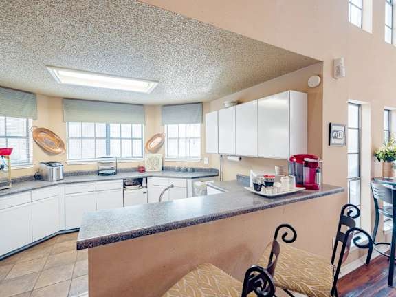 A kitchen with a large island and a sink.
