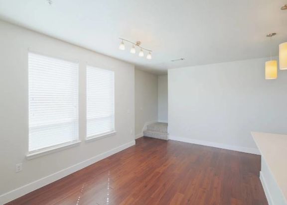A room with wooden floors and white walls.
