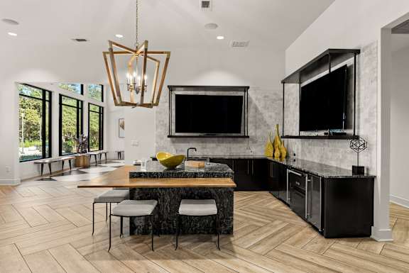 A modern kitchen with a black countertop and a large island. at Preserve at Rolling Oaks, Austin, TX, 78728