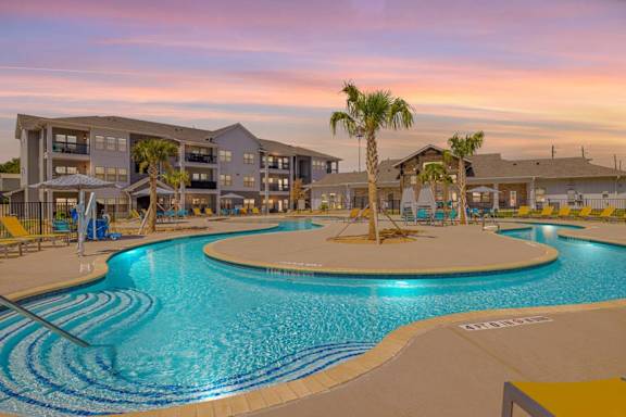 A pool with a palm tree in the middle of it.