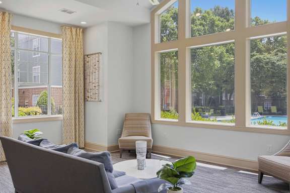 Bright community lounge with poolside views at Alden Place at South Square Apartments, Durham, North Carolina