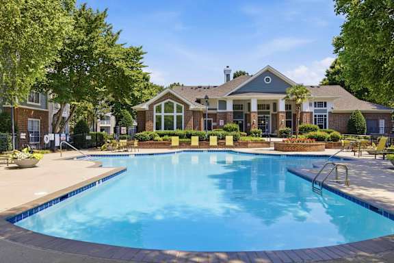 Resort style pool with clubhouse and lounge chairs at Alden Place at South Square Apartments, North Carolina