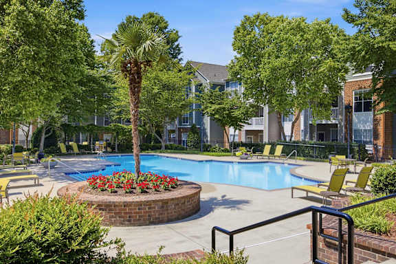 Swimming pool with palm tree planter and sundeck at Alden Place at South Square Apartments, Durham, NC 27707