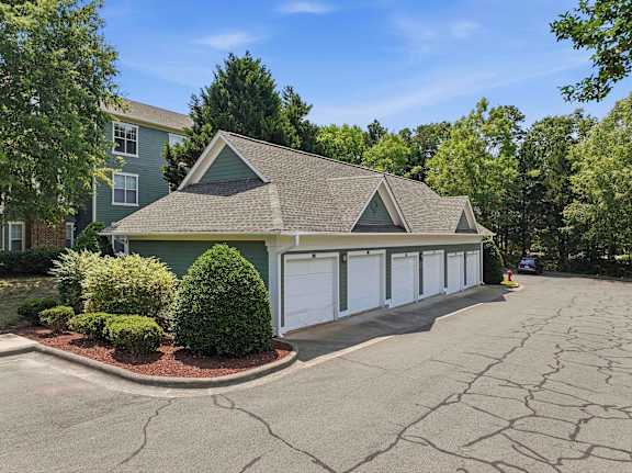 Five bay detached garage with white overhead doors at Alden Place at South Square Apartments, Durham