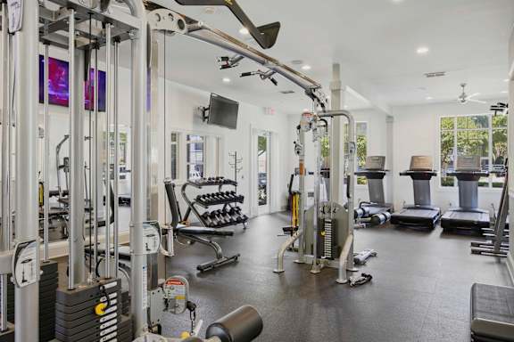 Fitness center with weight machines and cardio equipment at Alden Place at South Square Apartments, Durham