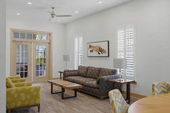 Clubhouse lounge with french doors and comfortable seating at Alden Place at South Square Apartments, North Carolina, 27707