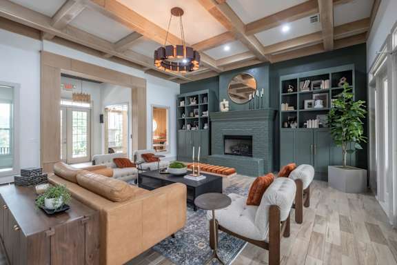 A living room with a brown sofa and a fireplace.