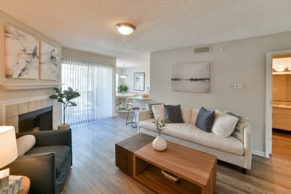a living room with a couch coffee table and a fireplace at Arbors Harbor Town, Memphis, TN, 38103